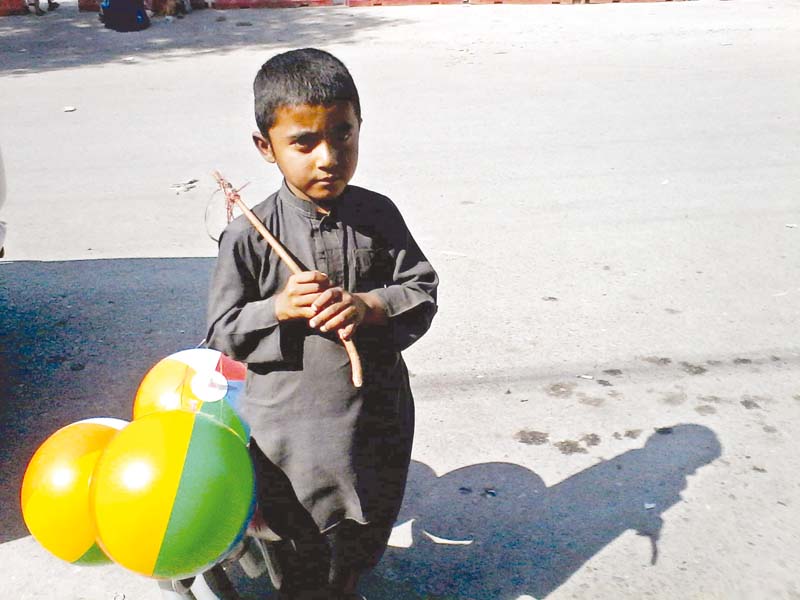 seven year old basimah left awaits customers in saddar and eight year old ikramullah right sells balloons in university town photo mahwish qayyum express