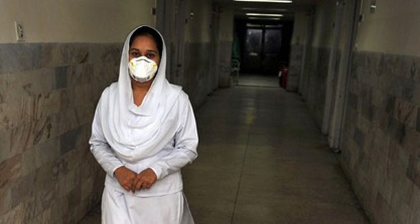 a paramedic leaves a room with swine flu patients at pims in islamabad photo afp