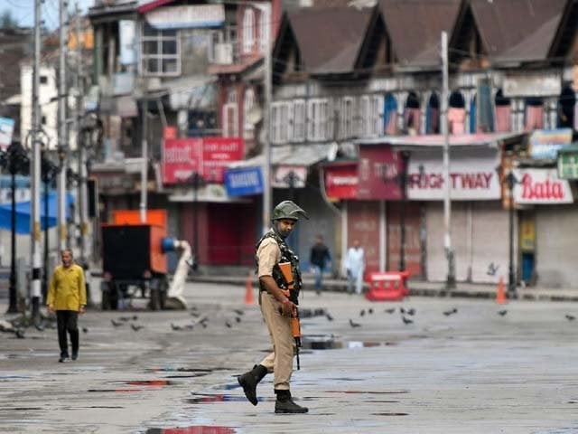 a security personnel patrols a deserted road in the lal chowk area in srinagar photo getty a security personnel patrols a deserted road in the lal chowk area in srinagar photo getty