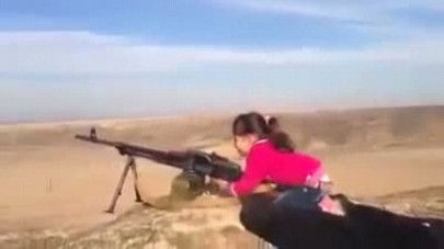 young kurdish girl filmed firing machine gun at is militants