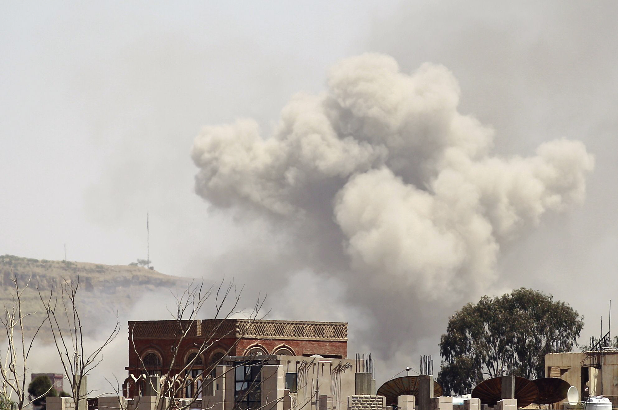 smoke rises above the alhva camp east of the yemeni capital sanaa on april 17 2015 following an alleged air strike by the saudi led alliance on houthi rebels camps photo afp