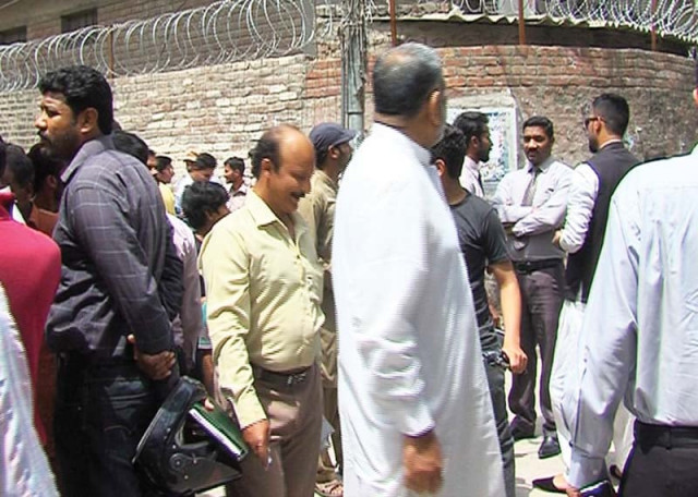 parents and residents of the area crowded the narrow street in front of the school after the incident photo shahbaz malik express