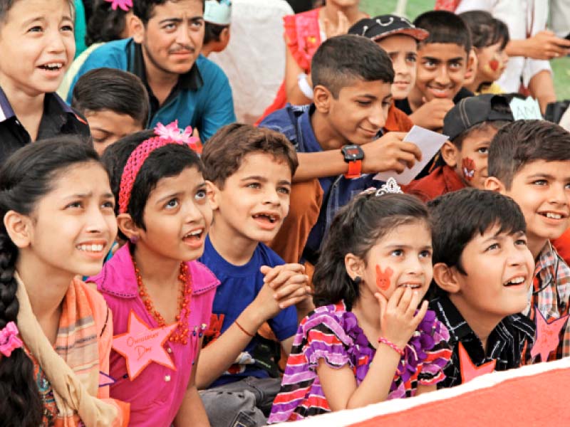 children watch the performances at aku s annual children s oncology party on friday photo aysha salim express