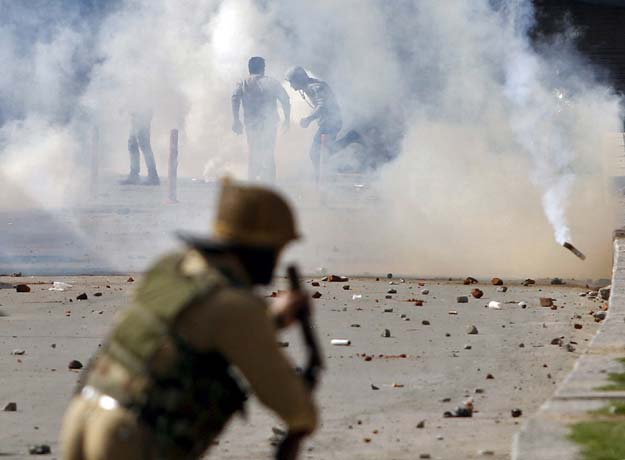 protesters run for cover amid smoke of tear gas fired by indian police during a demonstration in srinagar april 17 2015 photo reuters