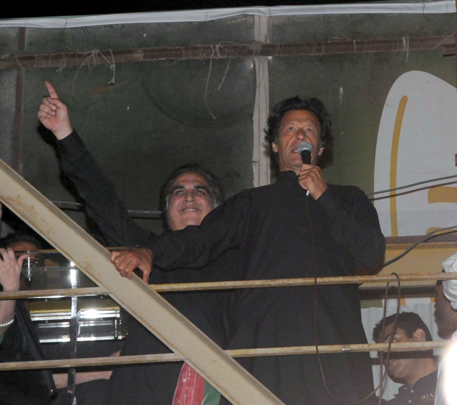 imran ismail stands behind pti chairman imran khan during party rally on sunday april 19 2014 photo mohammad noman express