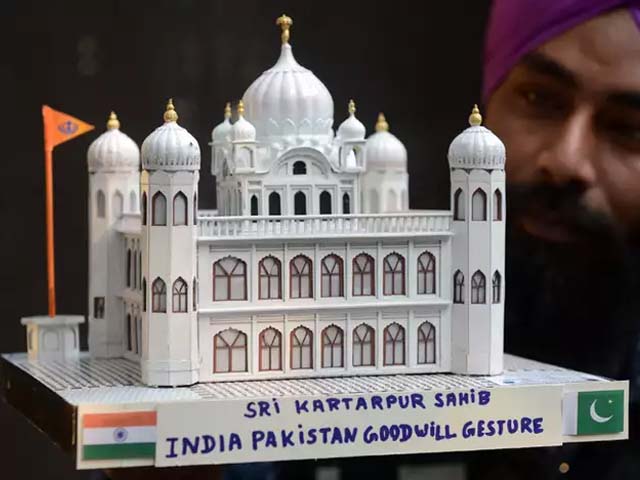 indian artist gurpreet singh poses with a paper model of the gurdwara kartarpur sahib in pakistan photo getty