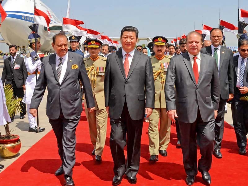 chinese president xi jinping accompanied by his pakistani counterpart mamnoon hussain and prime minister nawaz sharif walks out of the nur khan airbase in rawalpindi photo pid