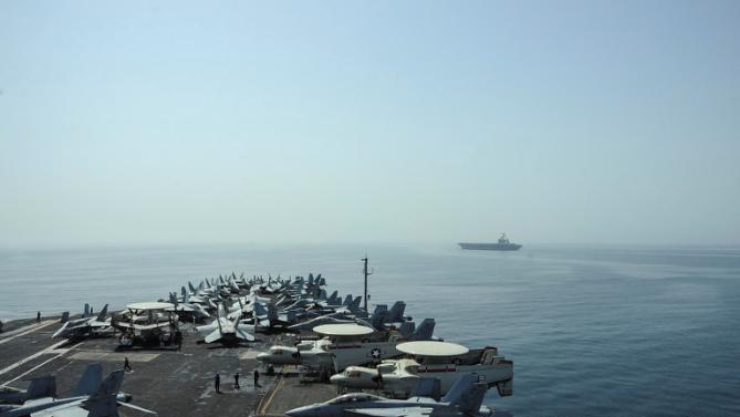 this us navy photo obtained april 20 2015 shows the nimitz class aircraft carriers uss theodore roosevelt and uss carl vinson in the gulf photo afp