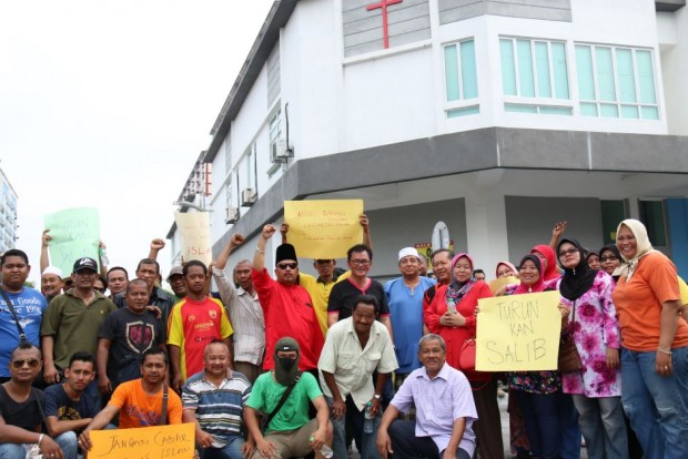 group of protesters say the christian symbol above the church is an affront to local muslims photo blazingcatfur