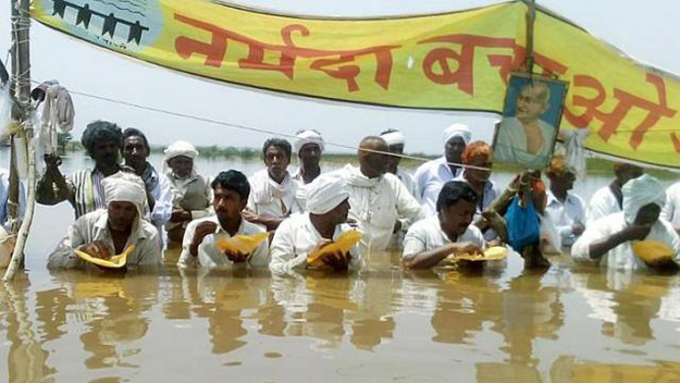 around 30 farmers have vowed to keep up their protest by standing in their fields which have been inundated with water by a nearby dam in madhya pradesh state despite concerns over their health on april 21 2015 photo afp