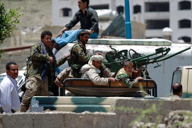 armed fighters of the shiite huthi movement sit in a pick up truck mounted with a machine gun in southern sanaa on april 21 2015 close to a missile depot on fajj attan hill that was hit by saudi led coalition air strikes photo afp