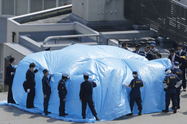 police and security officers investigate an unidentified drone under a blue cover which was found on the rooftop of prime minister shinzo abe 039 s official residence in tokyo in this photo taken by kyodo april 22 2015 photo reuters police and security officers investigate an unidentified drone under a blue cover which was found on the rooftop of prime minister shinzo abe 039 s official residence in tokyo in this photo taken by kyodo april 22 2015 photo reuters
