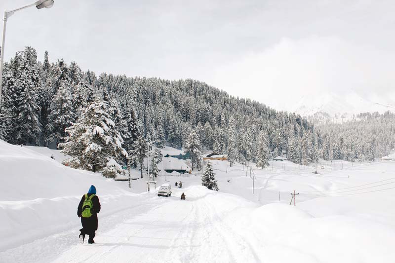 a kashmiri boy walks down a road in gulmarg known to be a world class skiing destination photos haziq qadri