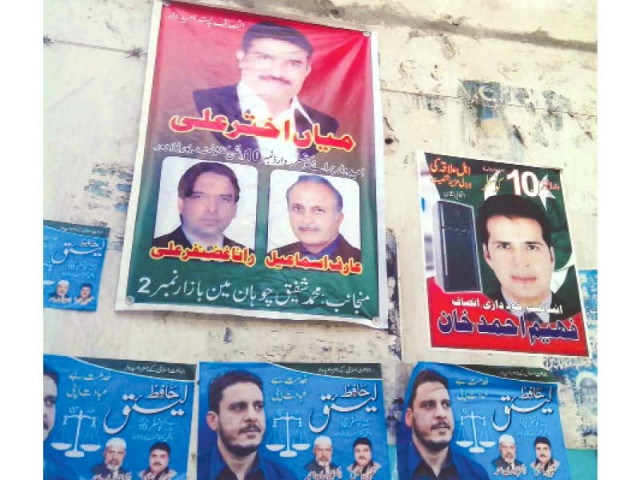 election posters plastered with pictures of all three candidates contesting the local government election from ward 10 photo rana yasif express election posters plastered with pictures of all three candidates contesting the local government election from ward 10 photo rana yasif express