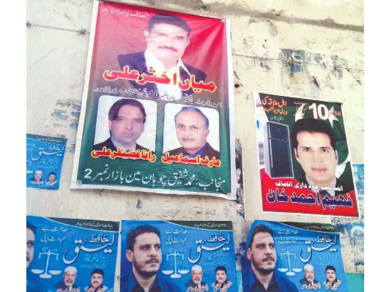 election posters plastered with pictures of all three candidates contesting the local government election from ward 10 photo rana yasif express