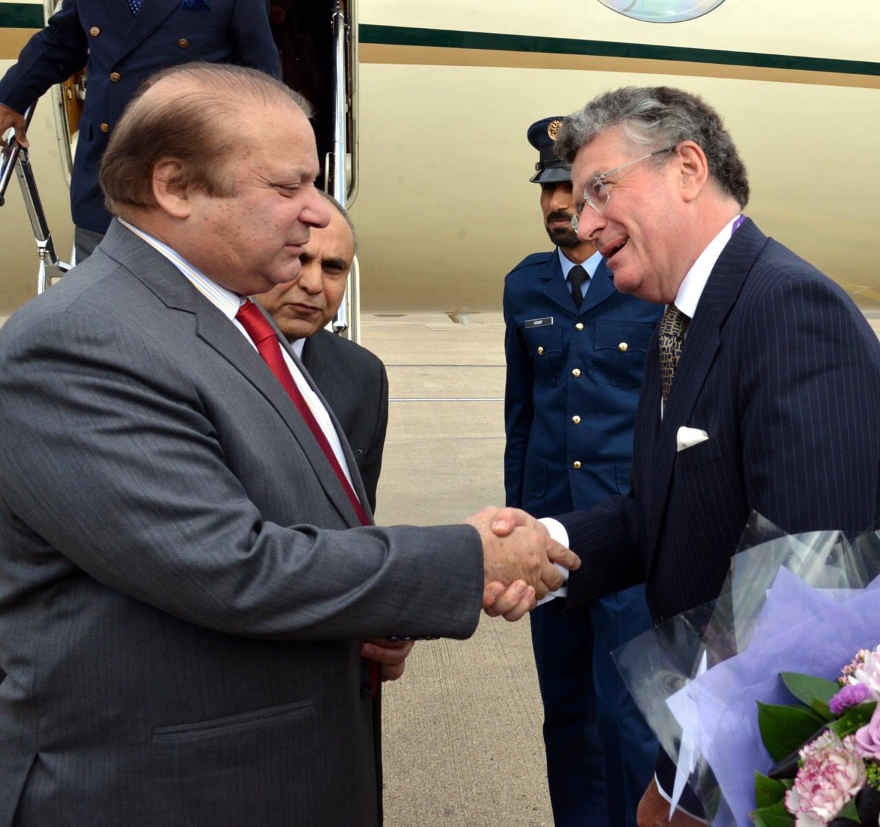 prime minister muhammad nawaz sharif being received by representative of the british government ambassador nicholas jarrold at heathrow airport photo official handout