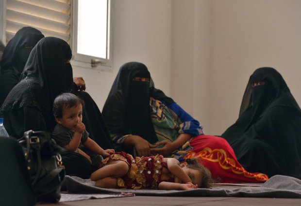 yemeni women sit with their children at a unhcr facility at obock in djibouti on april 12 2015