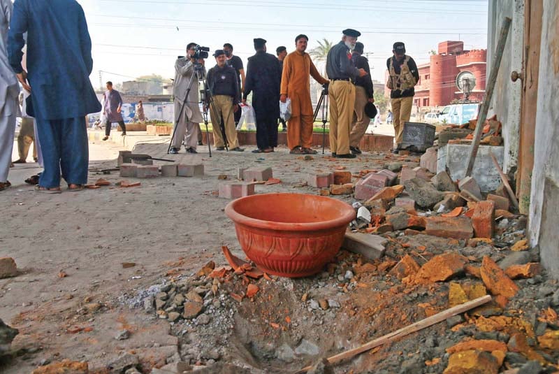 police inspect the blast site near gulbahar police station photos muhammad iqbal express ppi