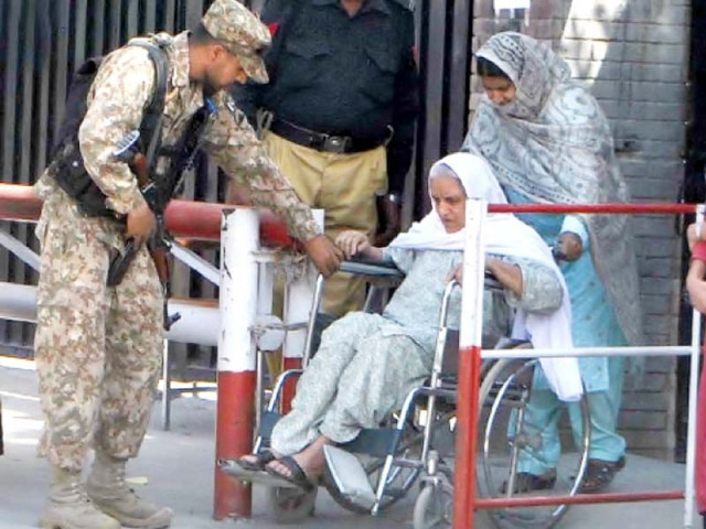 a soldier helps a senior citizen leave a polling station in rawalpindi after casting her vote photo inp a soldier helps a senior citizen leave a polling station in rawalpindi after casting her vote photo inp