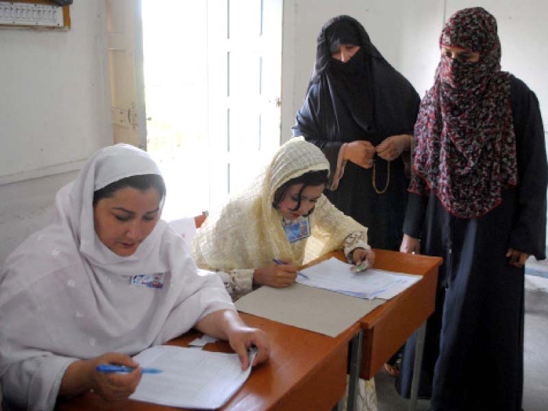 voters check their names in polling lists during cantonment board elections in peshawar photo ppi