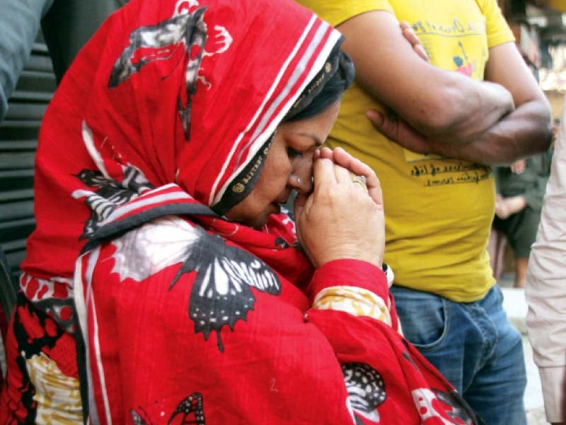 a woman supporter is seen praying during counting of votes photo abid nawaz