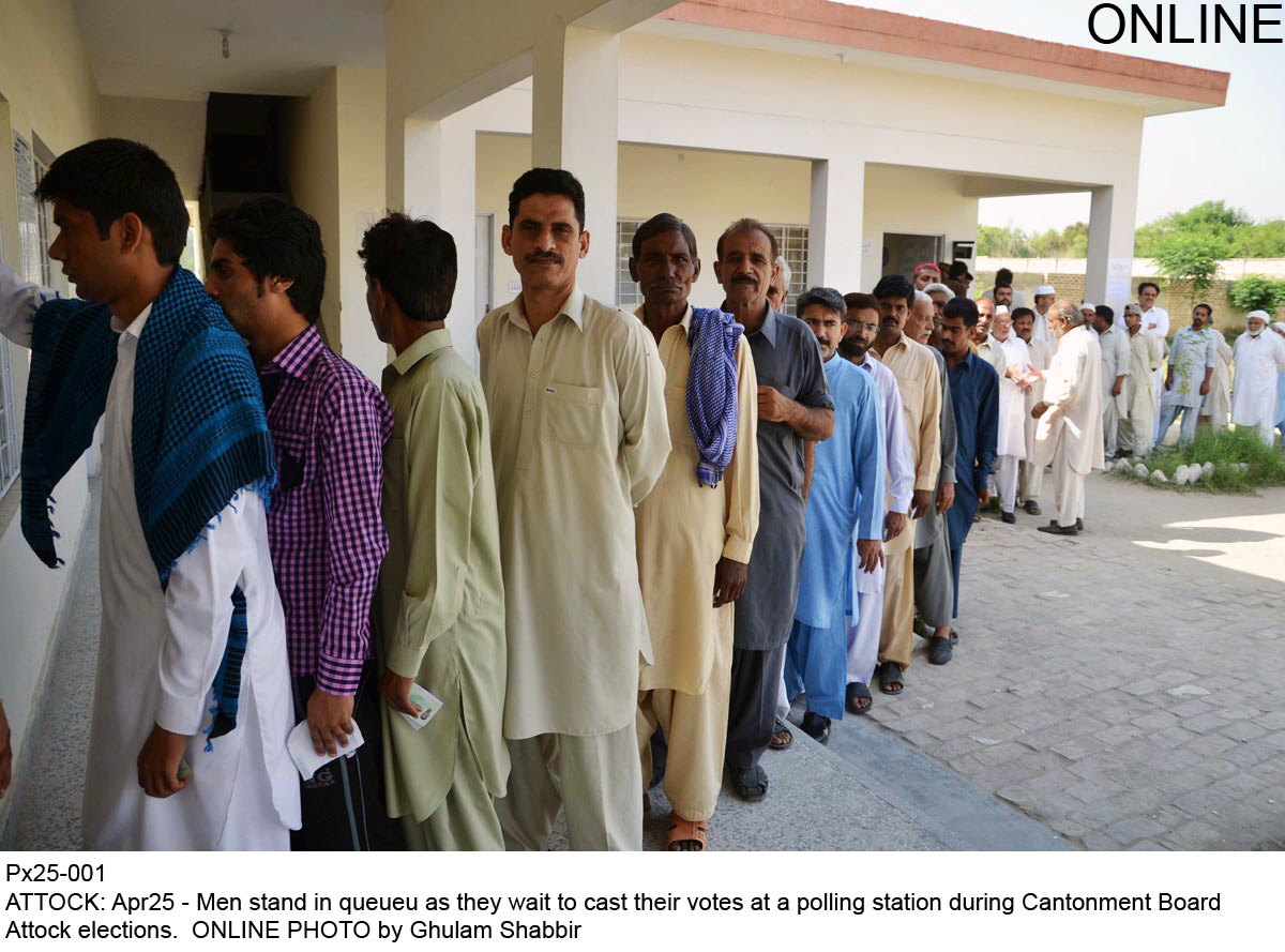 men stand in queue as they wait to cast their vote photo online
