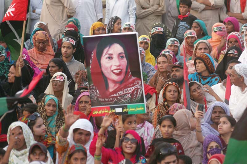 pakistan peoples party workers and supporters hold up a poster of benazir bhutto during the party s rally at kakri ground in lyari on sunday photo athar khan express
