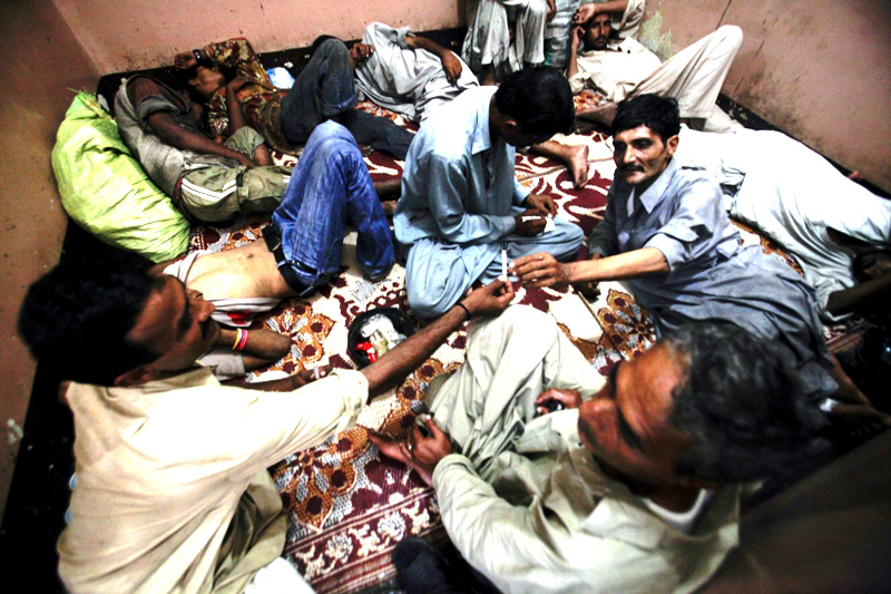 a drug addict passes a cigarette to another addict as they rest in a room of the hope rehabilitation centre in karachi in this september 8 2011 file photo photo reuters