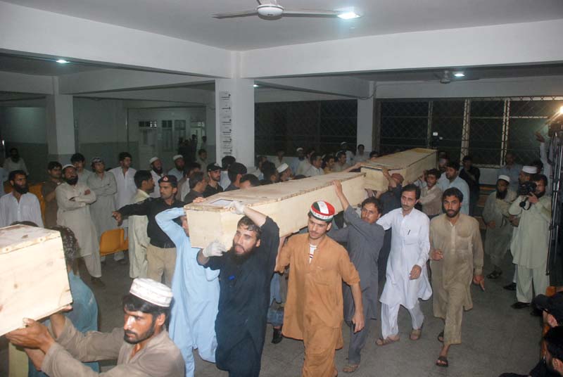 relatives carry the bodies of victims from the lrh in peshawar photo iqbal haider express