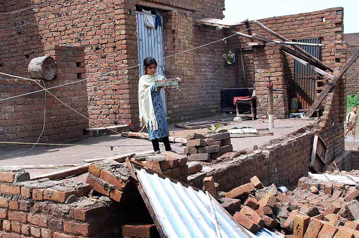 a girl salvages belongings after a storm passed through peshawar photo app
