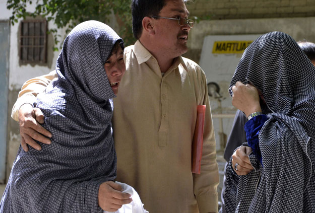 relatives grieve the deaths of the three men killed by motorcyclists on monday photo afp