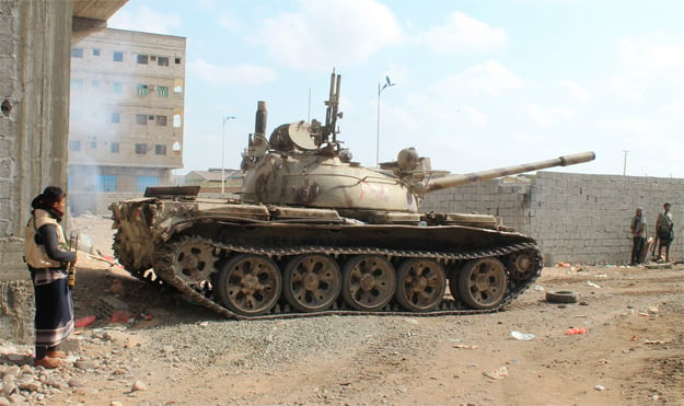 militiamen loyal to yemen 039 s fugitive president abderabbo mansour hadi stand next to a tank during clashes with opponents and huthi rebels in the port city of aden 039 s dar saad suburb on april 27 2015 photo afp