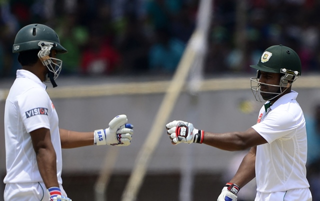 bangladesh cricketer tamim iqbal l celebrates with teammate imrul kayes r after hitting a boundary during the fourth day of the first cricket test match between bangladesh and pakistan at the sheikh abu naser stadium in khulna on may 1 2015 photo afp