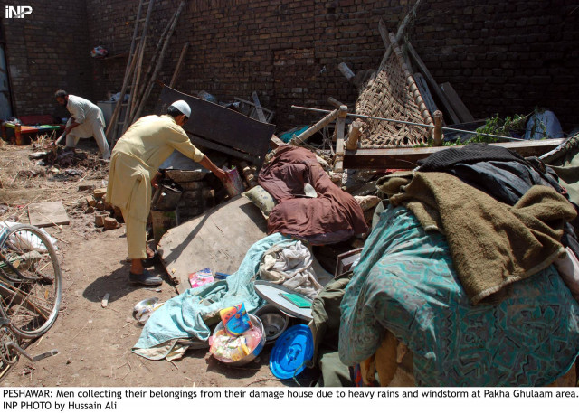 men retrieve their belongings from a rain damaged house in peshawar on tuesday photo inp men retrieve their belongings from a rain damaged house in peshawar on tuesday photo inp