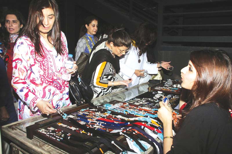 women examine jewellery designs at x 2 cafe on tuesday photo abid nawaz express