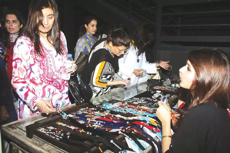 women examine jewellery designs at x 2 cafe on tuesday photo abid nawaz express women examine jewellery designs at x 2 cafe on tuesday photo abid nawaz express
