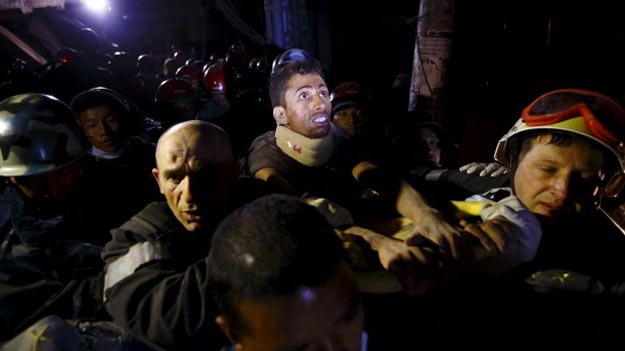 rishi khanal looks around at the surroundings as he is pulled from the rubble of a building after four days trapped photo reuters