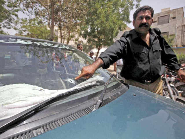 a policeman points at the bullet hole in the windscreen of slain ku professor waheedur rehman s car rehman was shot dead by unidentified men in fb area on wednesday photo reuters a policeman points at the bullet hole in the windscreen of slain ku professor waheedur rehman s car rehman was shot dead by unidentified men in fb area on wednesday photo reuters