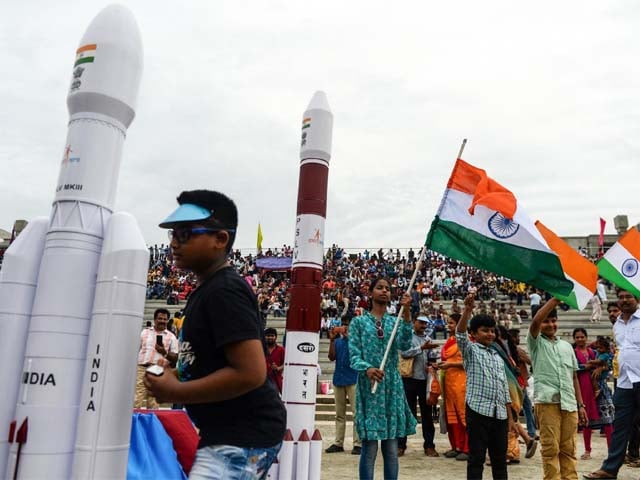 students wave indian national flags as the indian space research organisation isro photo afp