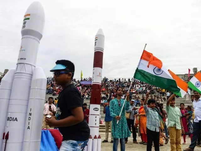students wave indian national flags as the indian space research organisation isro photo afp students wave indian national flags as the indian space research organisation isro photo afp