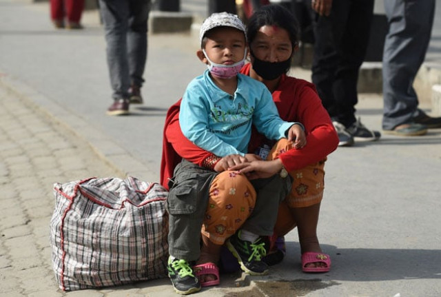 a nepalese woman and her son wear masks as they wait to board a bus at a bus station in kathmandu on may 2 2015 nepal has ruled out the possibility of finding more survivors buried in the rubble from a massive earthquake that killed more than 7 000 people and devastated vast swathes of one of asia 039 s poorest countries photo afp a nepalese woman and her son wear masks as they wait to board a bus at a bus station in kathmandu on may 2 2015 nepal has ruled out the possibility of finding more survivors buried in the rubble from a massive earthquake that killed more than 7 000 people and devastated vast swathes of one of asia 039 s poorest countries photo afp
