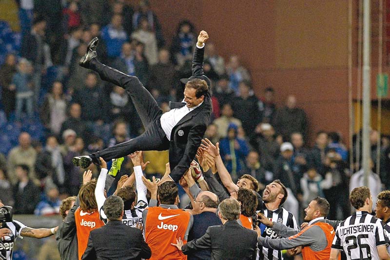 juventus players throw coach massimiliano allegri into the air after their 1 0 win over sampdoria awarded them their fourth title in a row photo afp