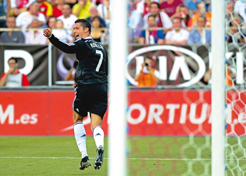 real came out unscathed out of their biggest remaining challenge to defeat a sevilla side unbeaten at home for more than a year thanks to ronaldo s heroics photo afp