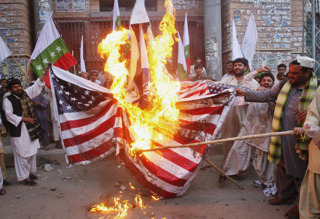 in this file photo demonstrators burn american flags as they protest against us photo reuters