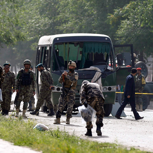 officials investigate the site of a suicide attack on a bus in kabul afghanistan on tuesday july 2 2014 photo reuters