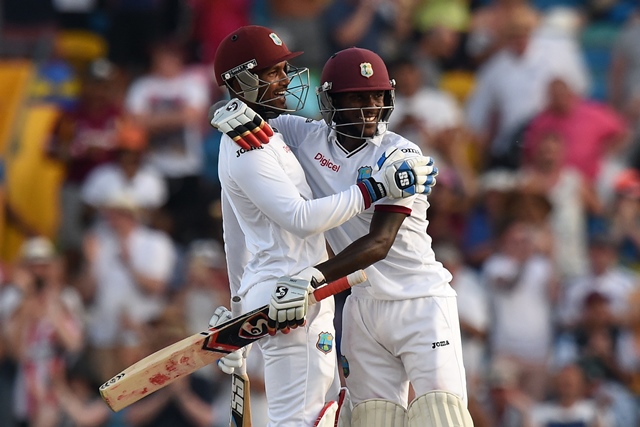 west indies cricket team captain wicketkeeper denesh ramdin l and batsman jermaine blackwood celebrate their victory during day three of the final match of a three match test series between england and west indies at the kensington oval stadium in bridgetown on may 3 2015 west indies defeated england by 5 wickets to draw the series 1 1 photo afp