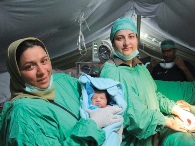 doctors show the child named pakistan born at army field hospital in nepal photo inp doctors show the child named pakistan born at army field hospital in nepal photo inp