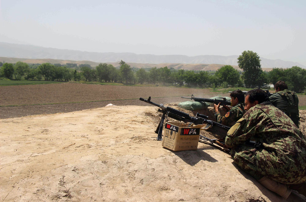 in this photograph taken on may 3 2015 afghan national army soldiers prepare to fire during a battle with taliban insurgents in kunduz intense fighting flared in northern afghanistan as security forces battled taliban insurgents advancing on a major provincial capital officials said with terrified residents fearing the fall of the besieged city hundreds of militants closed in on kunduz city after attacking outlying police and army checkposts on april 24 just hours after the taliban launched their annual spring offensive photo afp