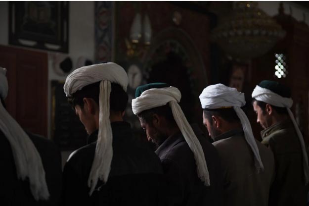 this photo taken on april 16 2015 shows uighur men praying in a mosque in hotan in china 039 s western xinjiang region photo afp