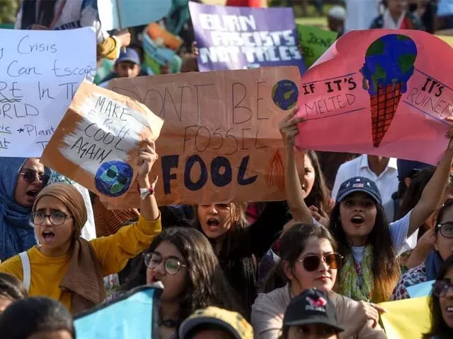 youths hold placards as they march for a climate strike to protest against governmental inaction towards climate change photo afp youths hold placards as they march for a climate strike to protest against governmental inaction towards climate change photo afp